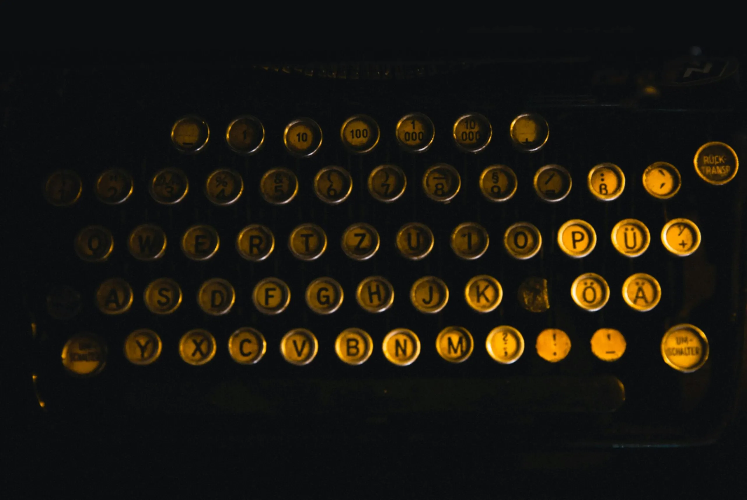 A vintage typewriter keyboard glowing in the dark, representing the high-quality content services offered by a Freelance Digital Marketing Strategist in Kochi.